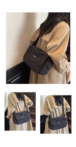 Detail of black nylon tote bag with flap closure and adjustable strap on a model