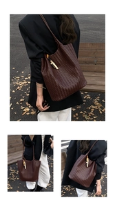 Detail view of brown woven leather tote with bohemian wood bead and tassel charms