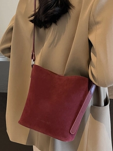 Minimalist burgundy suede bucket tote bag with adjustable shoulder strap for women