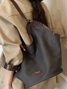 Chic large capacity grey canvas tote bag with brown leather trim and beaded charm detail