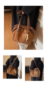 Detail of brown suede tote bag with drawstring closure and colorful wooden bead charm