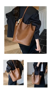 Detail of a dark brown woven tote bag with a wooden bead charm for daily commuting use
