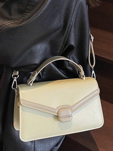 Minimalist light yellow leather shoulder bag with envelope flap and sleek top handle