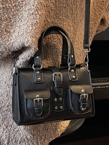 Chic black litchi grain leather handbag with multi-pocket design and crossbody strap