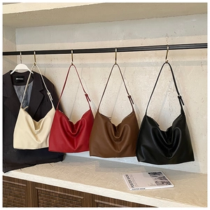 Litchi pattern leather hobo bags in four colors hanging on a metal display rack