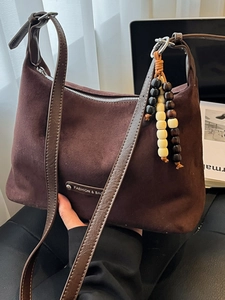 Chic dark brown faux suede tote bag with stylish beaded tassel and adjustable strap