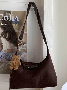 Brown suede hobo tote bag with plush star pendant and adjustable shoulder strap