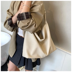 Detail of beige lychee pattern faux leather hobo bag showing texture and large capacity