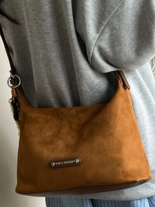 Minimalist brown suede tote bag with leather strap and decorative beaded pendant charm