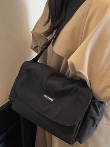Minimalist black nylon crossbody tote bag with adjustable shoulder strap for women commuting