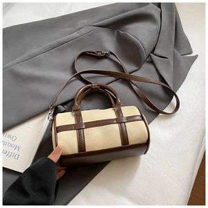 Chic beige canvas and brown leather Boston bag with crossbody strap and handles