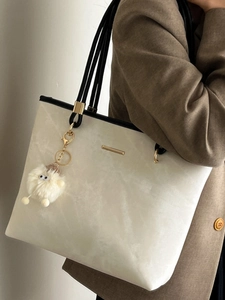 Minimalist cream tote bag with black contrast trim and cute sheep charm for women