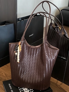 Dark brown woven leather tote bag with colorful beaded pendant and large capacity