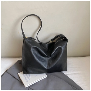 Macro detail of black lychee grain leather Hobo bag showing golden zipper and texture