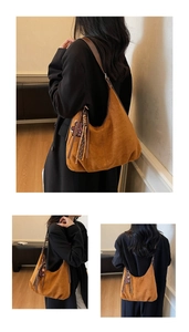 Detail of caramel suede hobo bag featuring decorative tassels and smooth leather texture