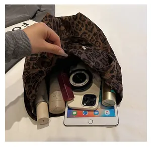 Detail showing the large interior capacity of this leopard print plush tote bag
