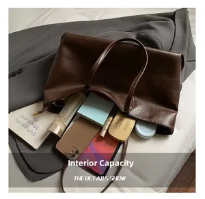 Detailed interior of large capacity brown tote bag showing storage for daily essentials