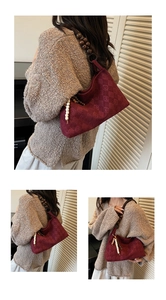 Close-up of retro burgundy shoulder bag with wooden beads and knit texture