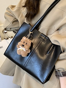 Vintage black PU leather tote bag with glossy texture and plush puppy charm detail