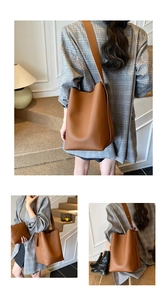 Detailed macro view of brown pebbled leather bucket bag with matching zipper pouch