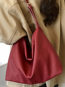 Large burgundy leather hobo bag with pebble texture and adjustable gold buckle strap