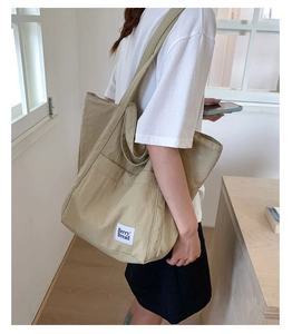 Detailed view of the large canvas tote bag with Berry Bread label and long shoulder straps