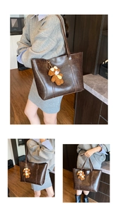 Detailed view of deep brown large tote bag with teddy bear charm and soft oil wax leather