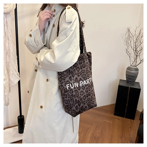 Detail view of large leopard print tote bag with Fun Party text on a canvas shoulder bag