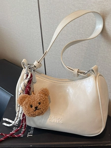 Minimalist cream white underarm baguette bag with cute brown bear plush pendant and charms