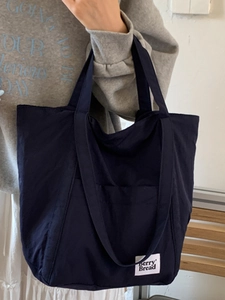 Minimalist navy blue canvas tote bag with berry Bread label for casual daily commute