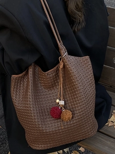 Retro deep brown woven leather tote bag with pompom charm for autumn commute