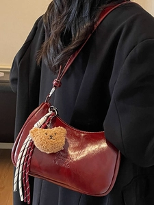 Retro dark red oil wax leather hobo bag with teddy bear charm and woven tassel details
