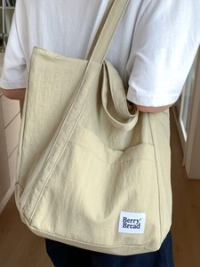Minimalist canvas tote bag with Berry Bread label shown as a stylish shoulder bag