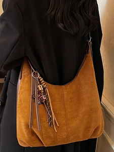 Vintage brown suede tote bag for women with tassel detail and retro crescent design