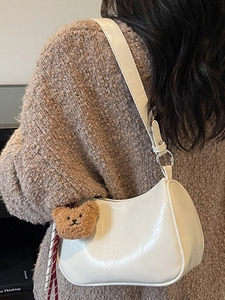 Creamy white vintage crescent underarm bag with cute brown bear charm for women