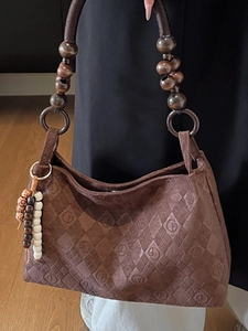 Brown suede tote bag with diamond quilting, wooden bead handle and GF logo for autumn fashion