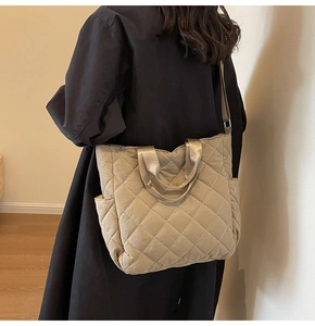 Vista dettagliata della borsa tote trapuntata in nylon kaki con texture e tasca laterale