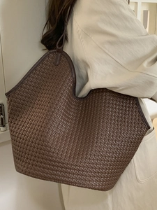 Brown woven bucket tote bag with wide U-shaped design for casual and office commute