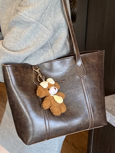 Brown large capacity leather tote bag with teddy bear pendant for women commuting