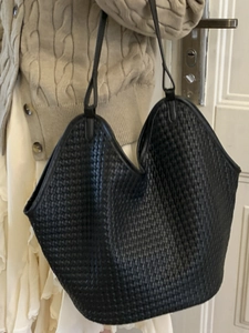 Chic black woven bucket shoulder bag for women featuring a spacious hobo tote design