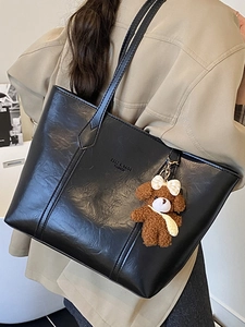 Classic black high-capacity tote bag in glossy PU leather with a cute bear charm pendant