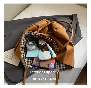 Detail shot of the spacious ginger tote bag showing plaid lining and internal storage space