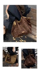 Detail of a large double-sided leopard print canvas tote bag with shoulder straps