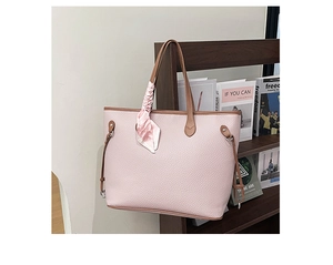 Detail view of pink litchi grain tote bag featuring floral scarf and drawstring accents