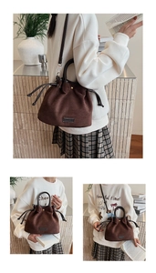Close-up of brown suede bucket bag with drawstring detail and adjustable crossbody strap
