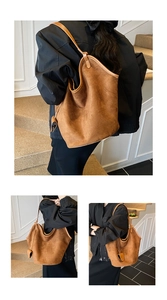 Detail of tan suede hobo bag showing large capacity and soft texture on white background