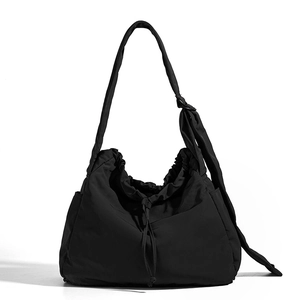 Detail view of the black drawstring bucket bag showing water-resistant nylon texture