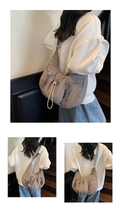 Detail view of water-resistant nylon crossbody bag with drawstring and zip pockets