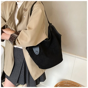 Detailed view of black oversized bucket bag with soft matte texture and leather trim