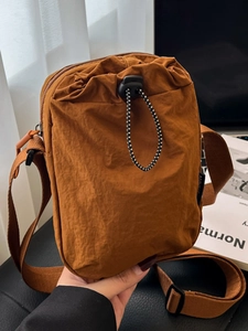 Minimalist caramel nylon crossbody phone bag with drawstring closure and wide strap